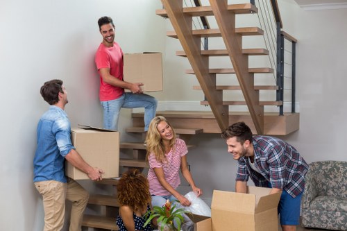 Professional movers handling household items in Hampton Wick