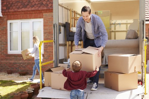 Professional movers handling furniture in Church End