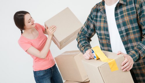 Experienced removal team loading boxes onto a moving truck