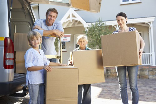 Movers packing boxes efficiently for a relocation in Woodford